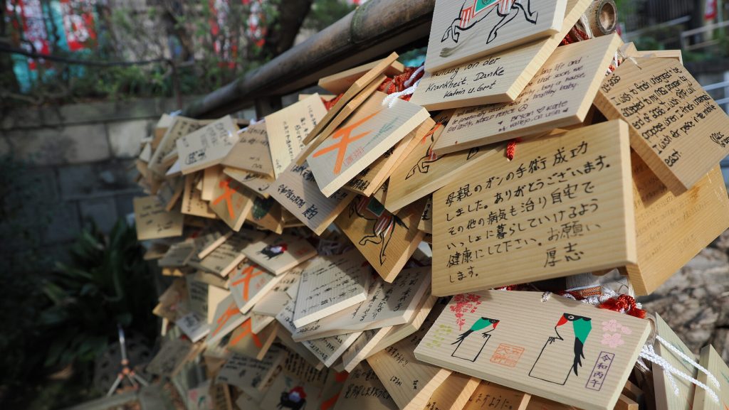 Zbliżenie na tabliczki ema z życzeniami po japońsku i niemiecku