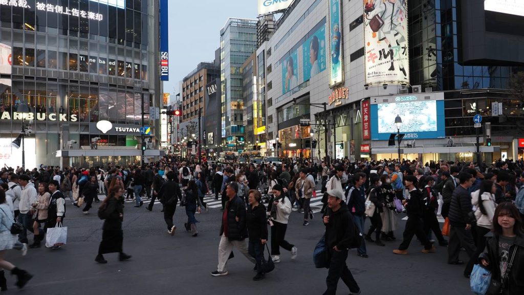 Shibuya Scramble Crossing wieczorem - setki pieszych w ruchu, Starbucks TSUTAYA i SEIBU w tle