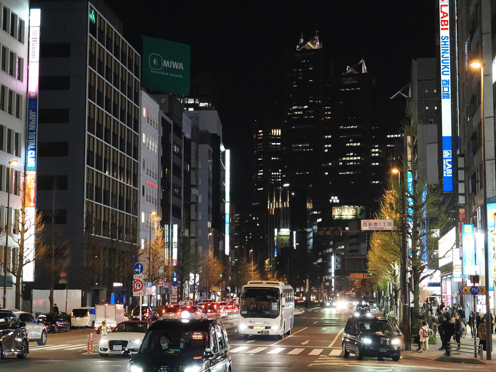 Nocna ulica Nishishinjuku w Tokio — wieżowce, neony LABI Shinjuku i ruch uliczny