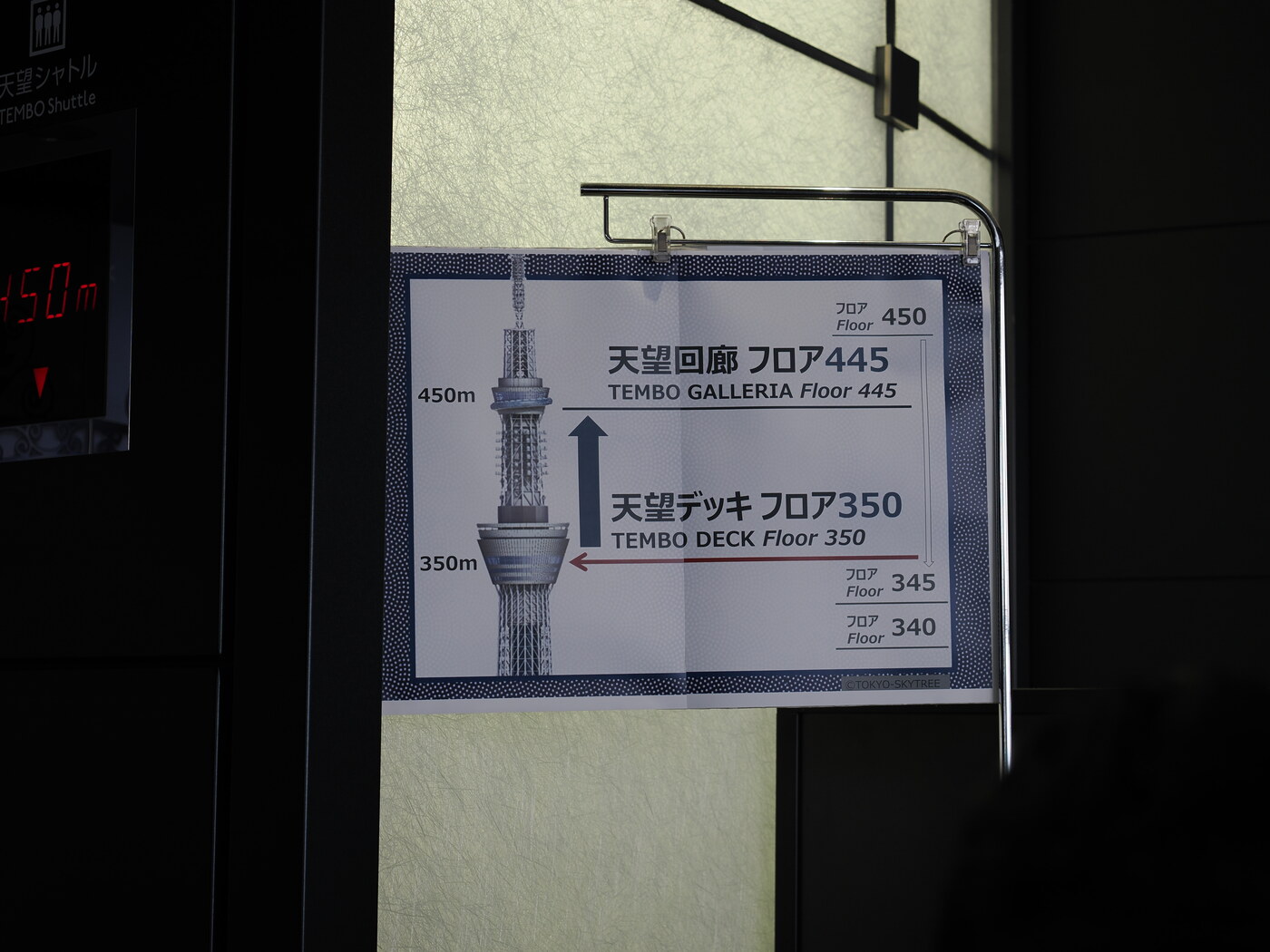 Tablica orientacyjna przy windzie Tembo Shuttle — schemat Skytree z zaznaczonymi poziomami: Tembo Deck Floor 350 i Tembo Galleria Floor 445