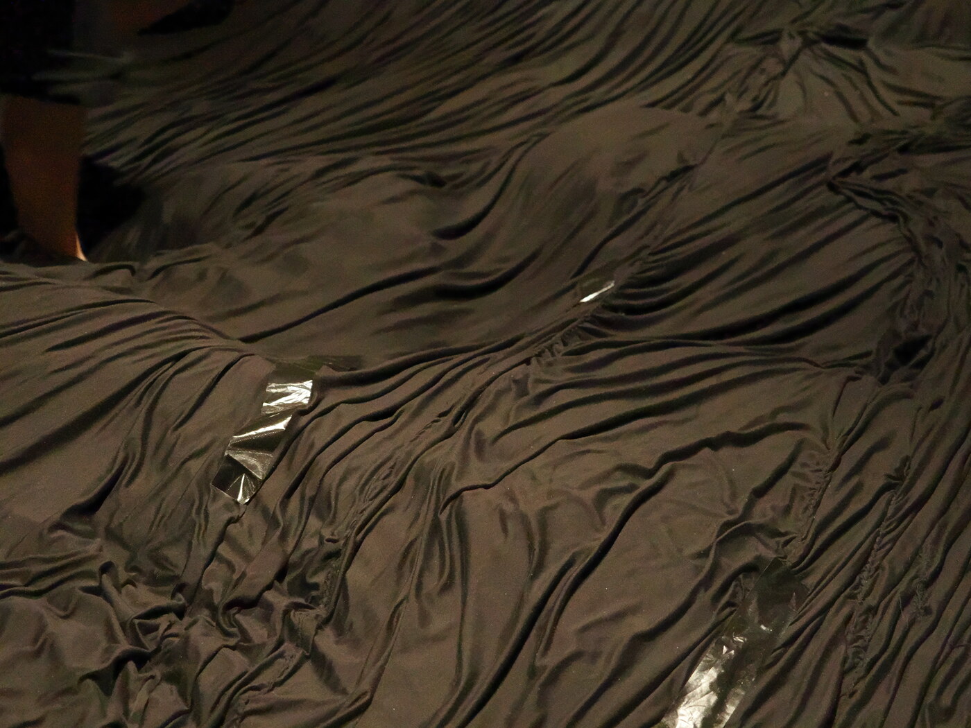 teamLab Planets — morze czarnego jedwabiu pokrywające podłogę z małymi błyszczącymi elementami, fałdy tkaniny falują pod stopami zwiedzających