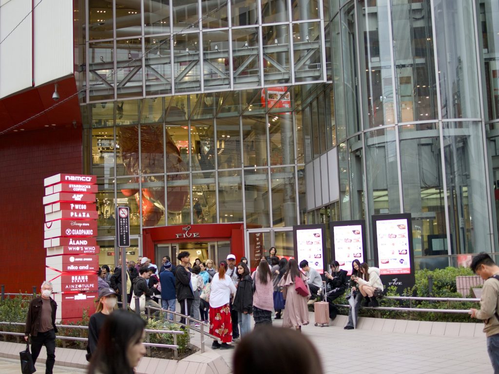 Wejście do HEP Five z czerwonym wielorybem w atrium i tłumem